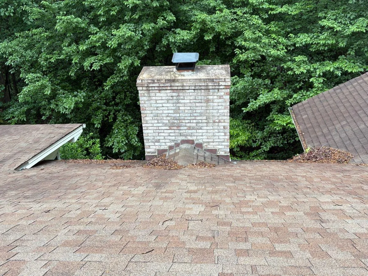 Roof and chimney base cleared of needles and debris