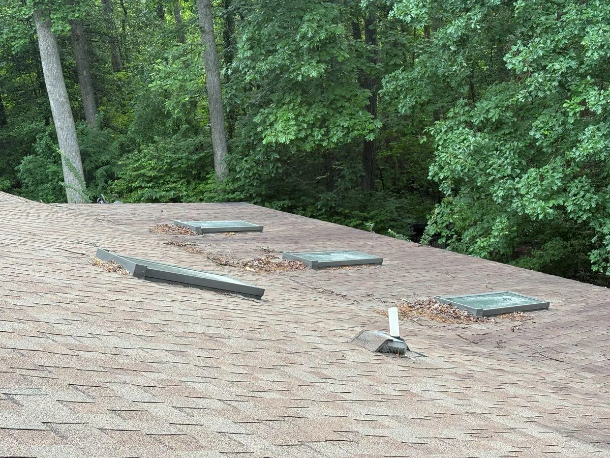 Skylights and surrounding shingle cleared of debris